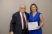 Dr. Nagib Callaos, General Chair, giving Prof. Liliane Azevedo Delage Miacci the best paper award certificate of the session "Educación, Globalización Académica y Sistemas de Información I." The title of the awarded paper is "Metodologías Activas en el Proceso de Enseñanza Aprendizaje Aplicadas en un Curso Superior de Gastronomía."